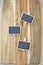 Three small chalk board signs on a wooden chopping board