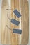 Three small chalk board tags on a wooden chopping board