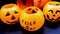 Three small empty plastic pumpkin baskets for trick and treat on black. background for halloween