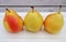 Three small Forelle pears in a row