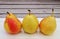 Three small Forelle pears in a row