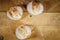 Three small loafs of French bread on display on a rustic wooden table, baguette style.