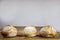 Three small loafs of French bread on display on a rustic wooden table, baguette style. T