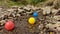 Three small primary colored plastic balls drifting down the stream