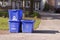 Three small recycle bins on curb