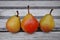 Three small Seckel pears in a row