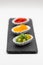 Three small tasting plates with different types of peppers red yellow and green peppers