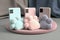 Three smartphones in soft pastel colors and shades, mobile phones in pink light green and sand color along with soft