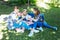 Three smiling friends sharing their secrets having picnic