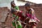 Three Smiling Little African Girls Busy Fetching Water At The Village Pump