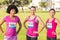 Three smiling runners supporting breast cancer marathon