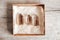 Three smoky natural quartz crystals in a kraft paper box on wooden background. Top view. Copy, empty space for text