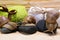 Three snail sits on a stone for spa treatments on a towel background