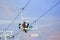 Three snowboarders sitting on ropeway