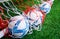 Three Soccer footballs in training goal net sport concept