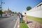 Three South Asian tourists with cameras happily hitchhiking the road behind Wat Pho during their long weekend happily. in Bangkok