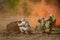 Three Soviet soldiers retreat from the battlefield using a smoke screen