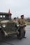 Three soviet soldiers standing near army lorry