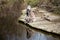 Three spider monkeys drinking from a river