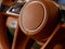 three-spoke steering wheel with orange leather in a luxury business car