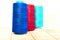 Three spools of thread. Navy, red and blue