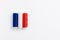 Three spools of thread for sewing are stacked in the form of the flag of France on a white background.