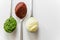 Three spoons with different condiments - mayonnaise, tomato sauce and pesto