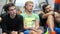 Three sports men sitting on the floor in the gym