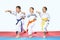 Three sportsman in karategi are hitting blows arms