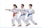 Three sportsmen are training blows hand on a white background