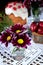 Three spring flowers. Easter cake and red coloured eggs in the background.