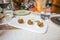 Three squid croquettes with alioli sauce and chive on white tray