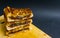 three stack of chocolate filled toasted bread on wooden cutting board with black background