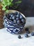 Three stacked ceramic bowls with ripe blueberries