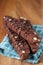 Three Stacked Chocolate Almond Biscotti on Wood with Napkin