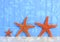 Three Starfish On Blue Background