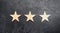 Three stars on a dark background. The concept of rating and evaluation of hotels, restaurants, mobile applications. Excellent