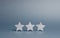 Three stars on a gray background. The rating of the hotel, restaurant, mobile application. Quality service, buyer choice. Success