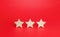 Three stars on a red background. Rating evaluation concept. Service quality. Buyer feedback. High satisfaction. Good reputation