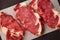 three steaks of raw marbled beef on parchment paper