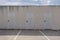 Three storage room doors against a blue sky. Simmetry in a minimalist background. Epmty copy space