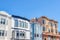 Three-storey houses with railings at the entrance and apartment above a store in San Francisco, CA