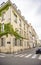 Three-storey residential house covered with green ivy