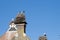 Three storks are in their nest on a chimney, in the spring , blue sky in background part of chimney