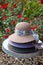 Three straw hats stacked on table in the garden