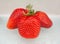 Three strawberries on white background