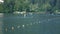 Three strong men rowing in boats on a beautiful lake, water sport and training