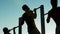 Three strong sportsmen doing actively pull-ups on chin-up bars outdoors, sport