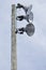 Three strong spotlights on a wooden post