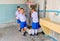 Three student boys are drinking water at cooling drinking water machine in their school. Hua Hin, Thailand September 10, 2016